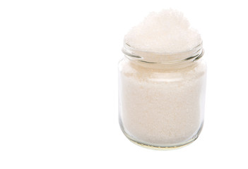 White refine sugar in a glass container over white background