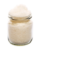 White refine sugar in a glass container over white background
