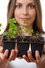 young woman holding plant,  celery sprout