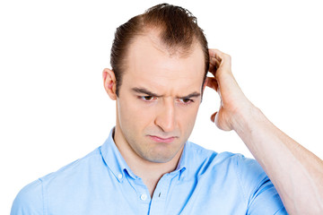 Headshot worried man scratching head remembering something 