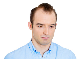 Obraz premium Headshot sad gloomy man deep in thought looking down 