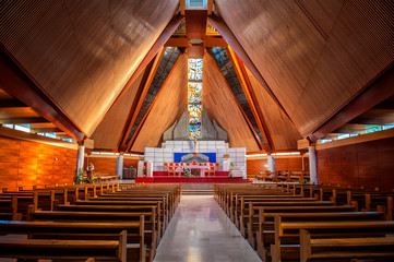 Interior of large modern catholic cathedral with high wooden cei