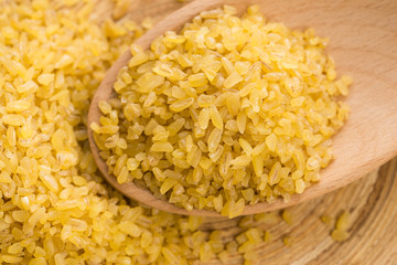bulgur wheat in wooden spoon