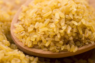 bulgur wheat in wooden spoon