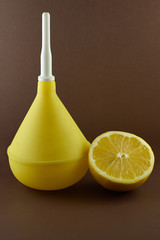 Medical enema with lemon on brown