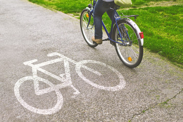 Fototapeta na wymiar Woman riding bicycle on a bike path