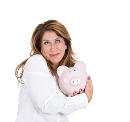 Portrait woman possessive about her savings, holding piggy bank