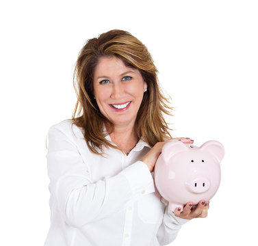 Portrait woman possessive about her savings, holding piggy bank