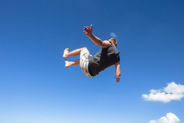 Boy Jumping Somersaults Blue Sky