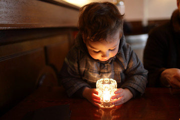 Child looking at candle