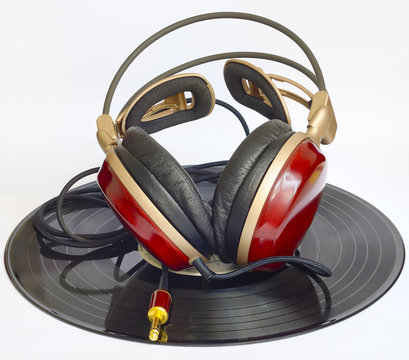 wooden headphones arranged over some old 45 rpm records