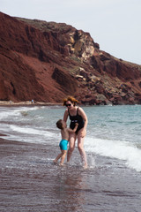 Fototapeta premium Mother and her little son playing on the beach