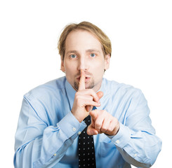 Shh. Business man asking to keep it quiet, silence please