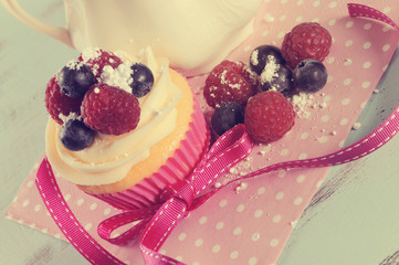Retro vintage cupcake with berries closeup