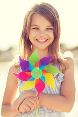 happy girl with colorful pinwheel toy