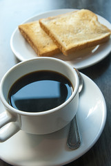 Coffee and  toast on wooden table