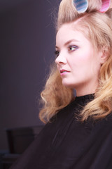 Fototapeta premium Blond girl hair curlers rollers hairdresser beauty salon