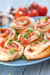 Puff pastry rolls with ham and chese. Baked snacks