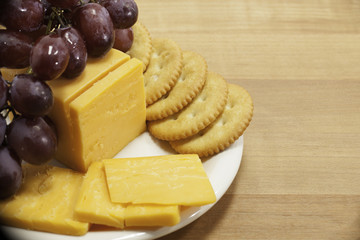 Cheese and Crackers with Grapes on Plate