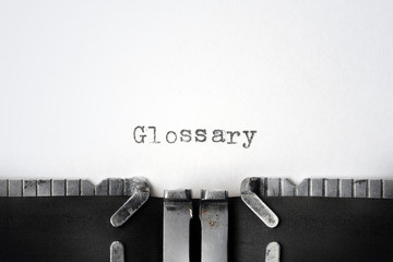 "Glossary" written on an old typewriter