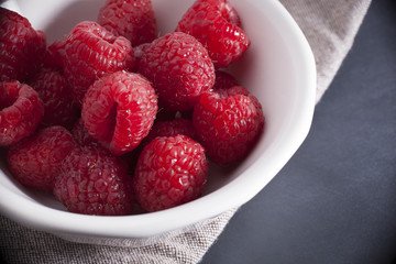Fresh Red Ripe Raspberries on Rustic Surface