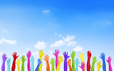 Colorful Hands Raised with Blue Sky