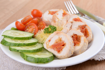 Delicious chicken roll on plate on table close-up