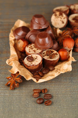 Fototapeta premium Tasty chocolate candies with coffee beans and nuts