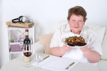 Tasty lunch for fat man, on home interior background