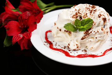 Tasty cake with cream, on black background © Africa Studio