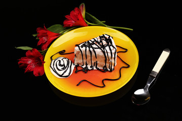 Tasty cake with cream, on black background © Africa Studio