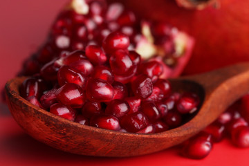 Ripe pomegranates on red background