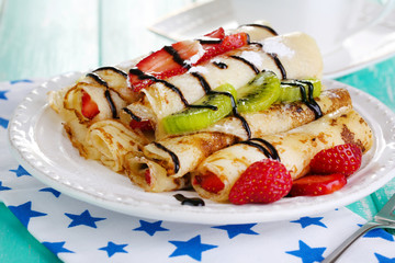 Delicious pancakes with strawberries and chocolate