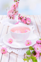 Beautiful fruit blossom with cup of tea