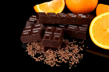 Chocolate and orange on black background