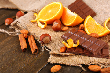 Chocolate, orange and nuts on table