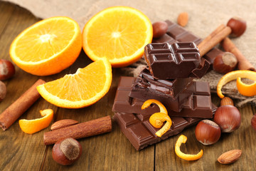 Chocolate, orange and nuts on table