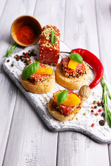 Composition of tasty sandwiches with salami sausage, basil leaf