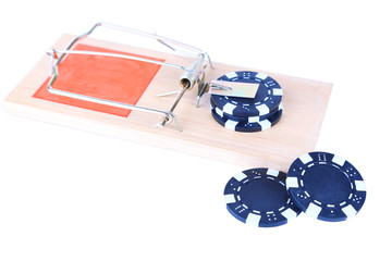 Mousetrap and casino chip isolated on white