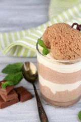 Tasty chocolate mousse with sorbet on wooden table