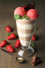 Tasty chocolate mousse with sorbet on wooden table