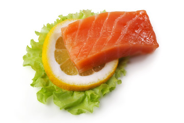 Composition with salmon, lemon slice and salad leaf