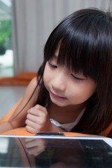 Girl playing with tablet.