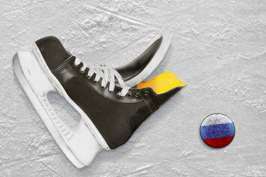 Hockey skates and puck
