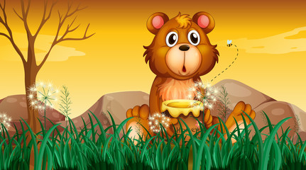 Obraz na płótnie Canvas A cute bear holding a pot of honey