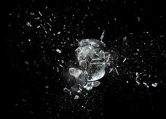 glass breaking black background. creativity fragility abstract