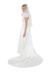 Fototapeta na wymiar Full length of thoughtful bride in wedding dress