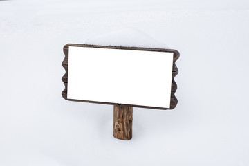 wooden signboard in snow