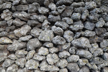 Etna's lava stones wall in a garden
