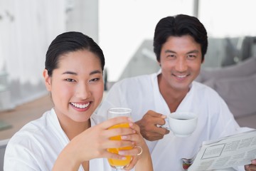 Couple in bathrobes spending the morning together